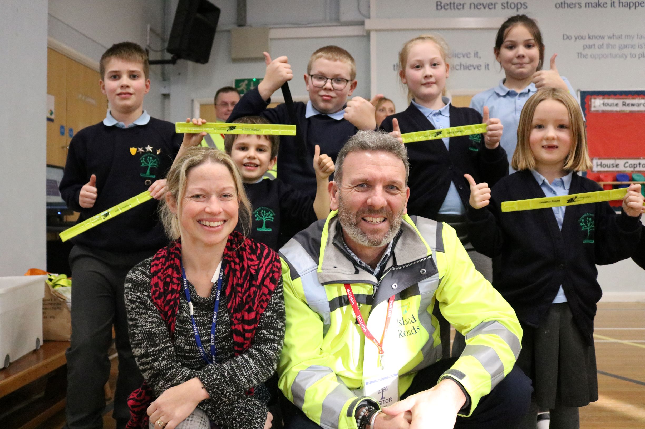 Photo shows pupils from Hunnyhill primary school with their teacher and a member of Island Roads staff at a safety talk