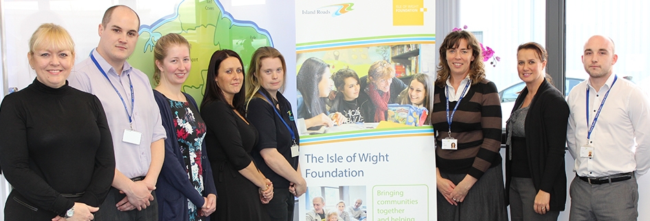 Photo showing Island Roads staff members with the Isle of Wight Foundation banner