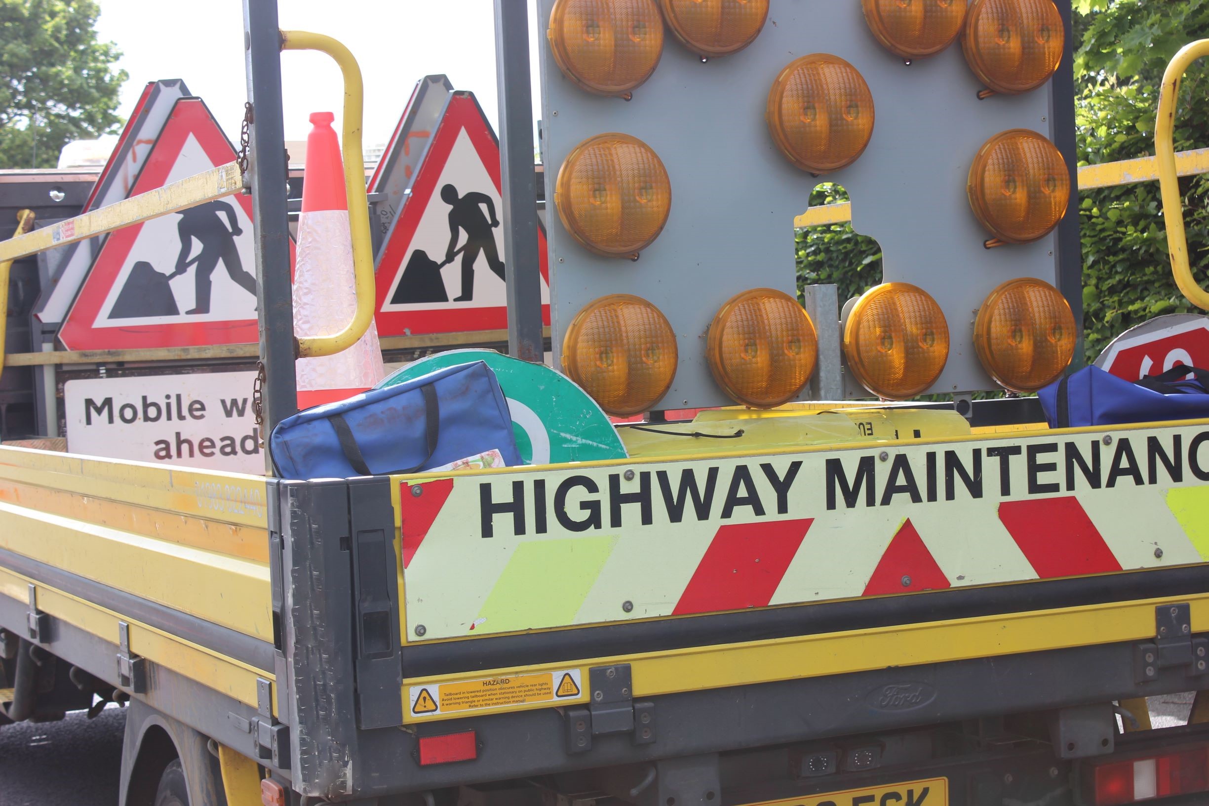 Photo showing highway maintenance vehicle loaded up with signage for site works