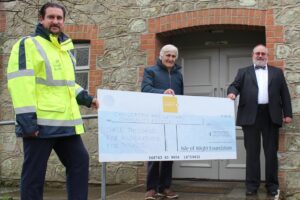 Photo showing Island Roads employee and members of Chillerton & Gatcombe community association holding a large cheque from the Isle of Wight Foundation
