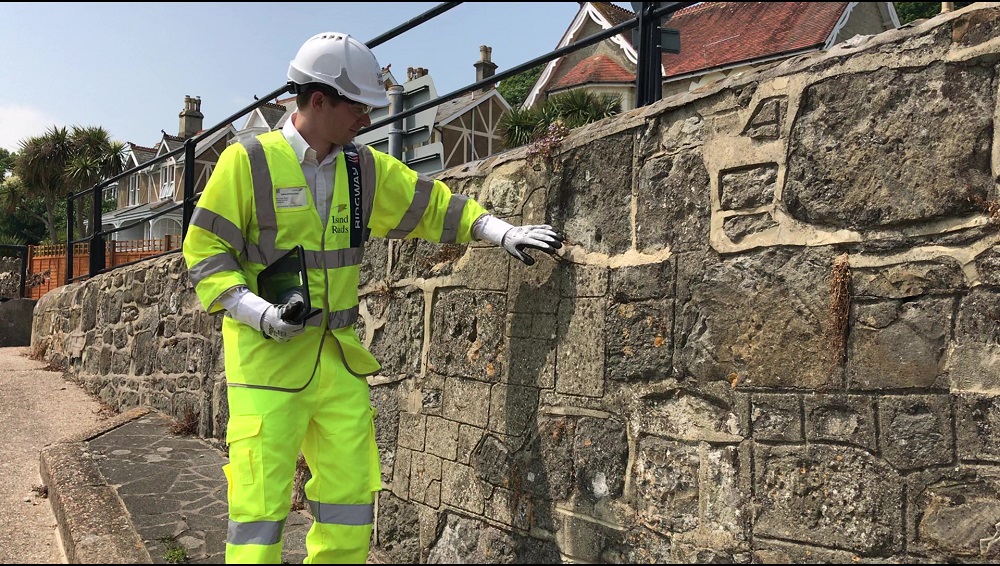 man inspecting wall