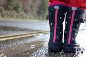 child's welly boots by puddle