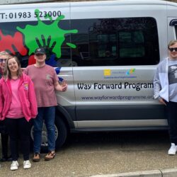Samantha O'Rourke, from Isle of Wight Foundation (left) with customers of The Way Forward and Way Forward CEO Tracey Hill, in front of the minibus partly funded by the IW Foundation.