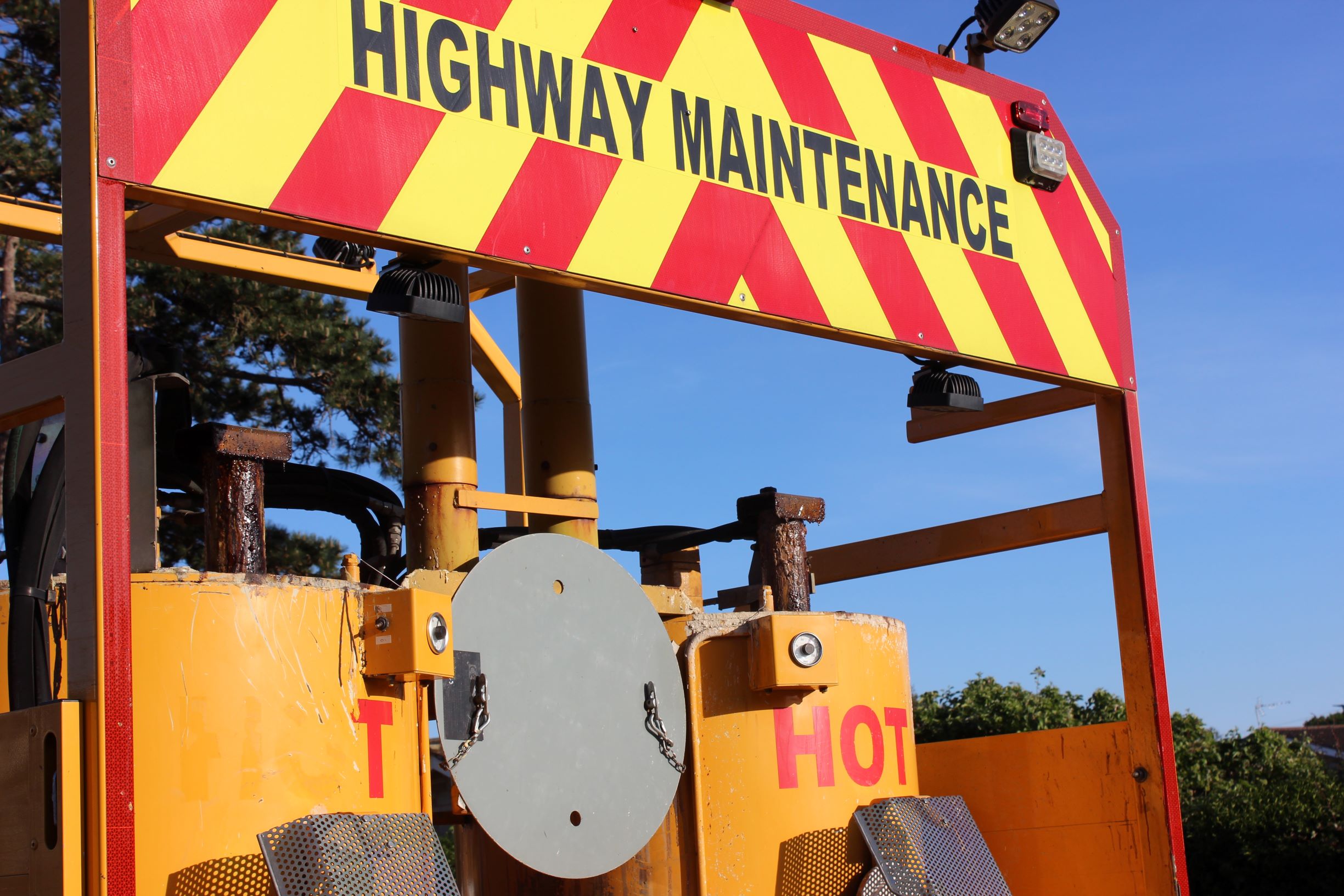 Photo showing reverse of maintenance lorry with highway maintenance sign and equipment