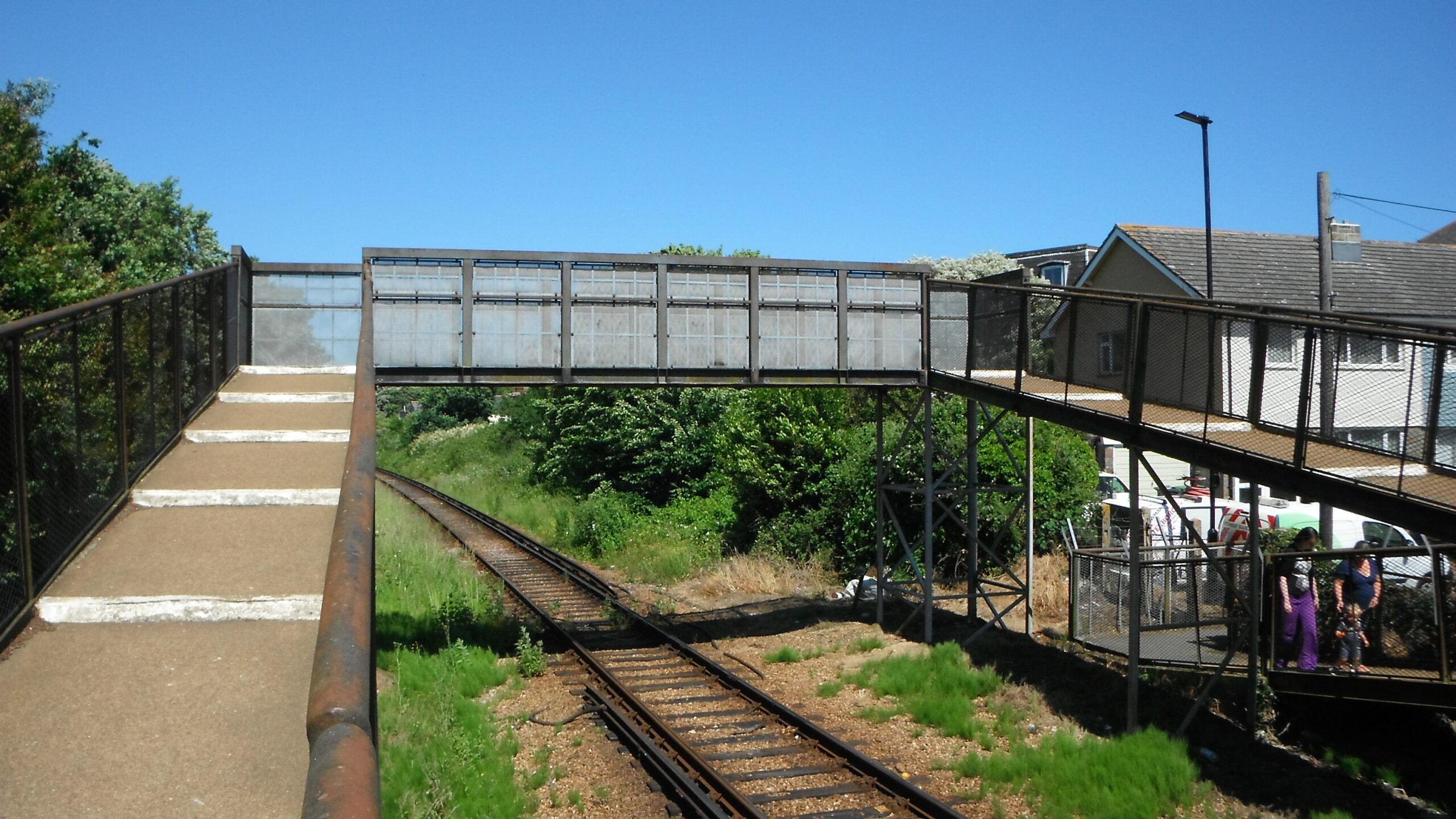 Photo showing a footbridge going across the railway track at Arelsford Road.
