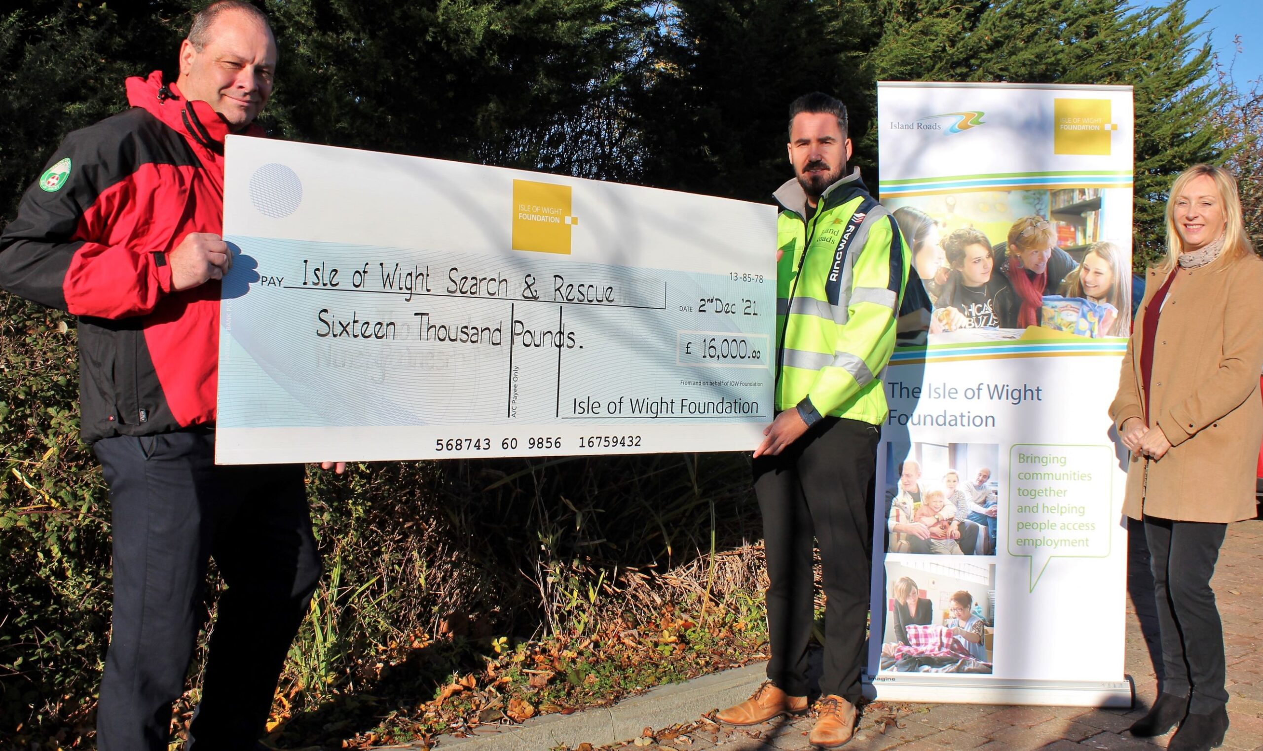Picture shows Dean from WightSAR receiving a cheque for £16,000 from Island Roads representatives