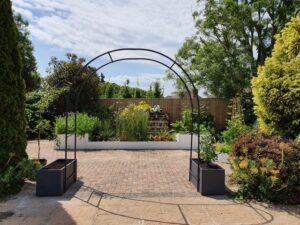 pretty garden with metal archway