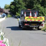 Highway maintenance vehicle parked on a single track road on the Isle of Wight
