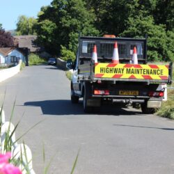 Highway maintenance vehicle parked on a single track road on the Isle of Wight