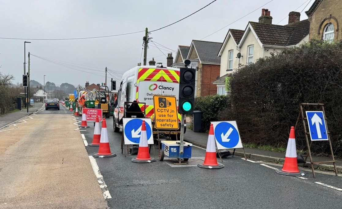 road works on right hand side of carriageway, traffic lights in use, green light showing